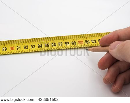 A Man Puts A Pencil Mark On The Number 100