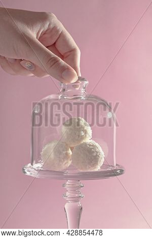 Round Sweet Candies In Coconut Shavings In A Glass Vase On A Pink Background, Harmony Of Taste, Exqu