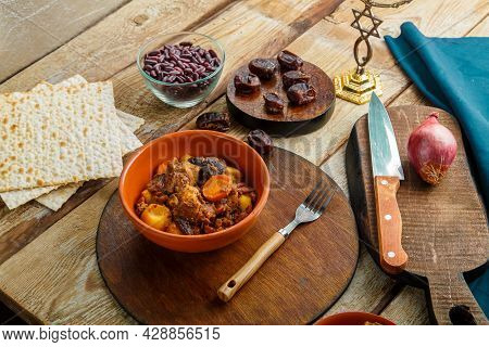 Jewish Dish Shuttle With Meat In A Dish On A Wooden Table Next To Matzo. Fork And Ingredients.
