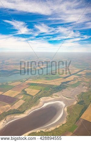 Land View Through The Airplane Window. Fields, Roads, Rivers From A Bird's Eye View. Porthole. Look