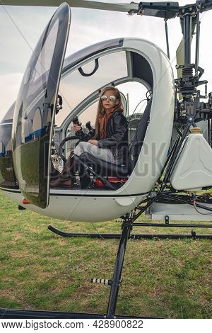 Tween Girl In Mirrored Sunglasses Sitting On Pilot Seat In Helicopter