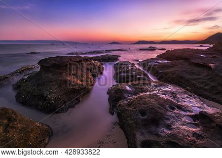 Very Colourful Sunset Over Rocks On The Coast