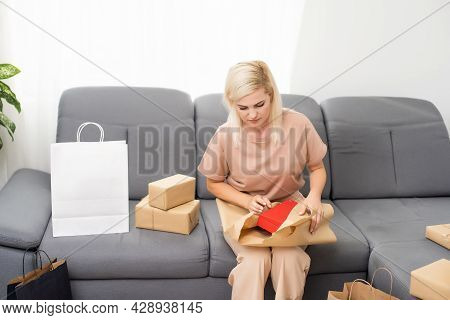 Smiling Satisfied Young Woman Customer Sit On Sofa Unpack Package Open Parcel, Happy Woman Consumer 