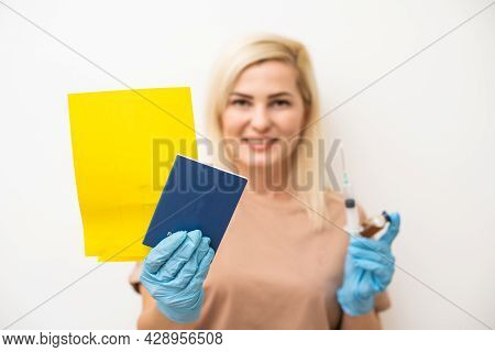 Woman Holding Inernational Certificate Of The Vaccination. Adult Showing The Information About Her V