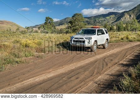 Great Sand Dunes National Park and Preserve - September 15, 2017: Toyota 4runner SUV (2016 Trail edition) with recovery sand ladders on roof driving on a sandy Medano Pass Road in late summer.