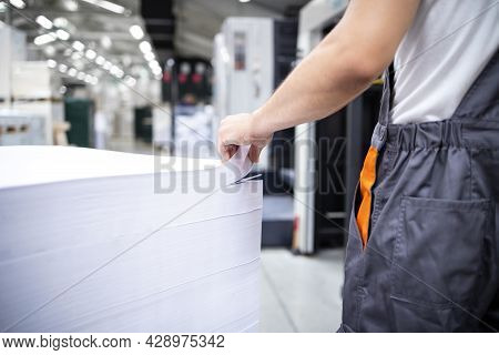 Shot Of An Unrecognizable Print Worker Ready To Place Blank Sheets Of Paper Into Offset Machine For 