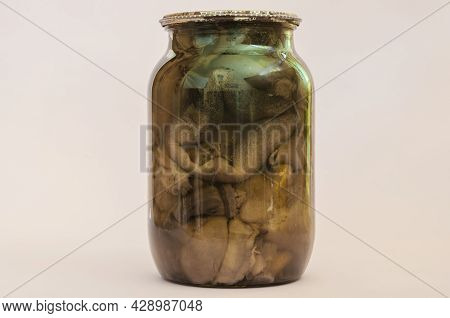 Botulism, Food Poisoning From Canned Foods Concept. Glass Jar With Homemade Pickled Mushrooms In Fro