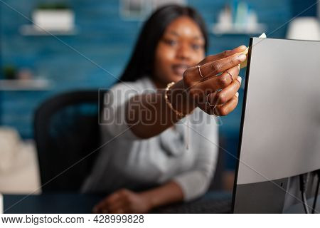 African American Student Putting Stickey Notes On Computer Working Remote From Home At Communication