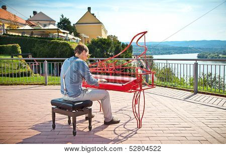 Young pianist play on his piano with bright emotions, Novi Sad, Serbia.