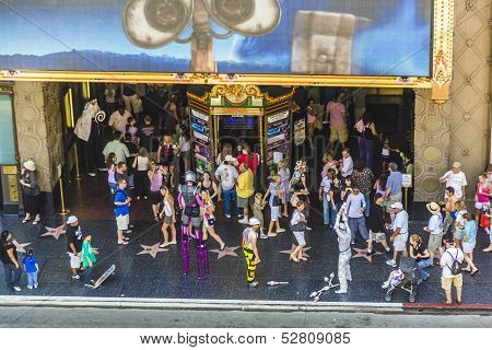 LOS ANGELES, USA - JULY 5: people walk along the walk of fame and at cinema el capitan actor doubles earn money on July 5 2008 In Hollywood USA. The art deco cinema belongs nowadays to Disney Corporation.