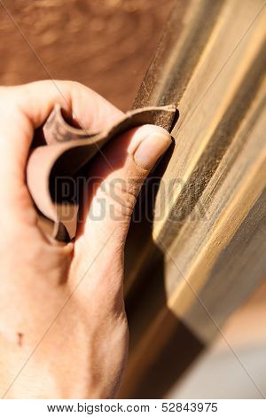 Hand of a woman sanding fixtures