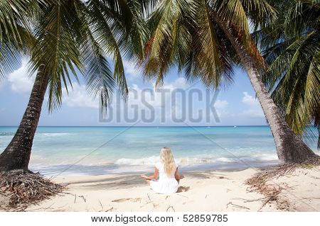Women Meditating On The Beach