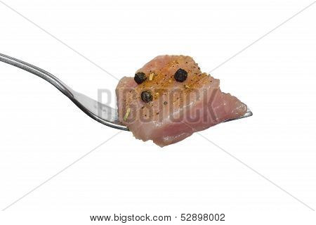 A Small Piece Of Raw Meat With Spices On A Fork