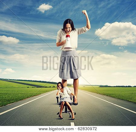 sad woman and angry screaming woman on the road at outdoor