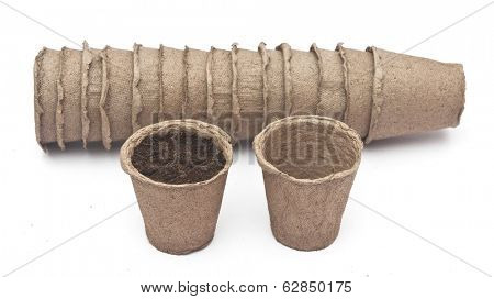 pile peat pots for growing seedlings, isolated on white background 