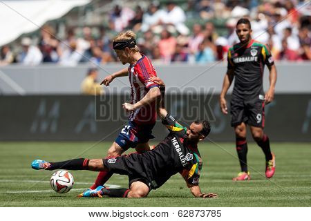 CARSON, CA - APRIL 6: Los Angeles Galaxy M Juninho (19) & Chivas USA M Kristopher Tyrpak (21) during the MLS game between the Los Angeles Galaxy & Chivas USA on April 6th 2014 at the StubHub Center.