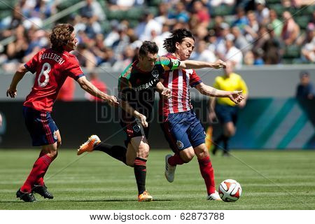 CARSON, CA - APRIL 6: Chivas USA M Mauro Rosales (7) & Los Angeles Galaxy F Robbie Keane (7) during the MLS game between the Los Angeles Galaxy & Chivas USA on April 6th 2014 at the StubHub Center.
