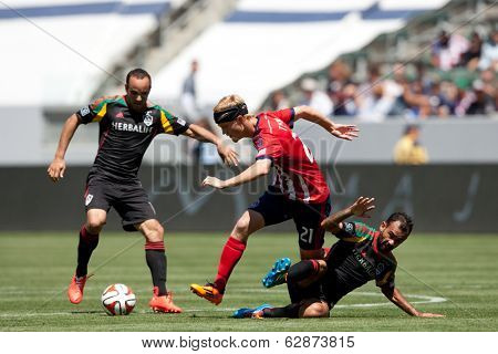 CARSON, CA - APRIL 6: Los Angeles Galaxy M Juninho (19) & Chivas USA M Kristopher Tyrpak (21) during the MLS game between the Los Angeles Galaxy & Chivas USA on April 6th 2014 at the StubHub Center.