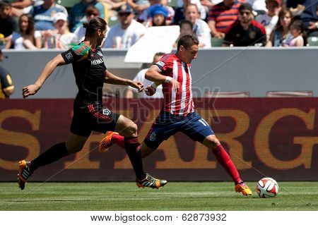 CARSON, CA - APRIL 6: Chivas USA M Leandro Barrera (11) & Los Angeles Galaxy D Omar Gonzalez (4) during the MLS game between the Los Angeles Galaxy & Chivas USA on April 6th 2014 at the StubHub Center