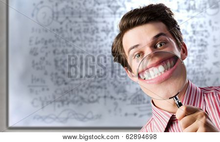 Young funny man scientist using magnifying glass