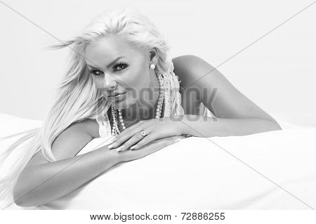 Beautiful Blond Woman On A Bed