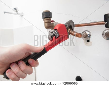 Hands Repairing The Plumbing Pipes Of An Electric Boiler