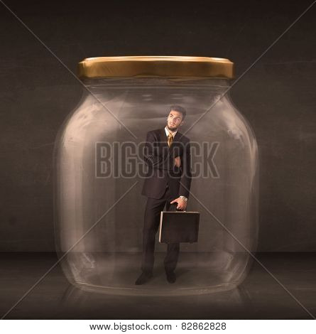 Businessman shut into a glass jar concept on background