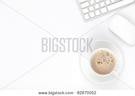 Office desk table with computer and coffee cup. Top view with copy space