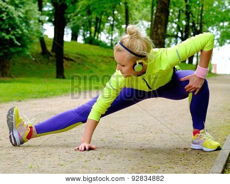 Woman doing stretching exercise before running 
