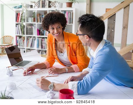 Two desingers working on a project together in office