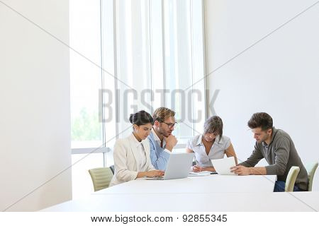 Business people meeting around table in modern space