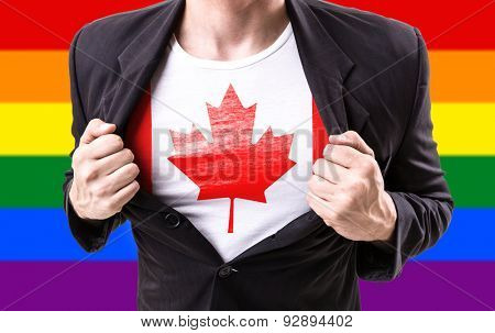 Businessman stretching suit with Canada Flag with rainbow flag
