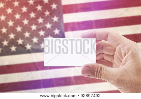 Man Holding Blank Business Card Against Usa National Flag