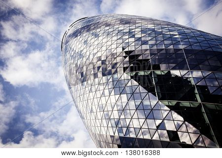 LONDON, UK - JUNE 17TH 2016: Looking up at the magnificent Gherkin skyscraper (30 St. Mary Axe) in the City of London on 17th June 2016.
