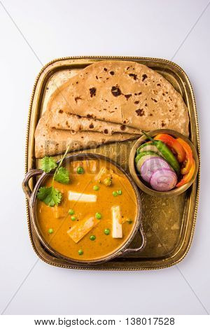 indian food paneer butter masala served with chapati / roti / paratha / fulka / indian bread with green salad