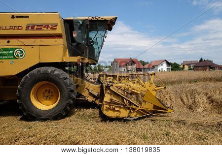 TRNOVEC, CROATIA - JULY 09, 2016: Combine harvester harvest ripe wheat on a farm in Trnovec, Croatia on July 09, 2016