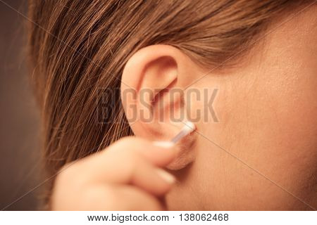 Woman Cleaning Ear With Cotton Swabs Closeup