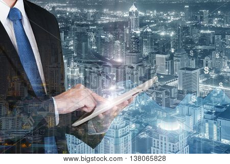 Business technology concept - Double exposure of business man using the tablet with financial business graph.