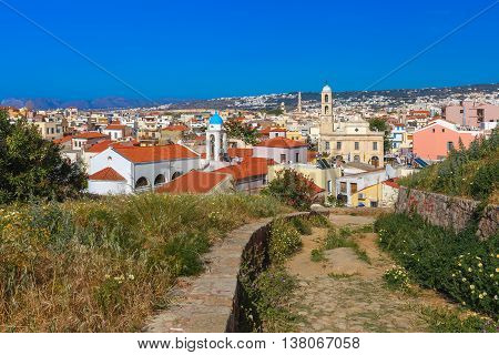 The medieval city with Orthodox cathedral Trimartiry, aerial view from Schiavo Bastion in the sunny morning, Crete, Greece