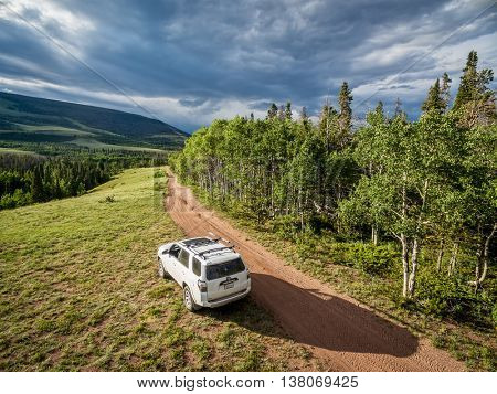 RED FEATHER LAKES, CO, USA - JUNE 3, 2016: Toyota 4Runner SUV (2016 Trail edition) on a back country road in Colorado's Rocky Mountains - aerial view
