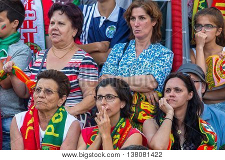 PORTO, PORTUGAL - JUL 10, 2016: Portuguese fans during translation of the football match Portugal - France final of the European championship 2016, in Liberdade Square at city center of Porto. 
