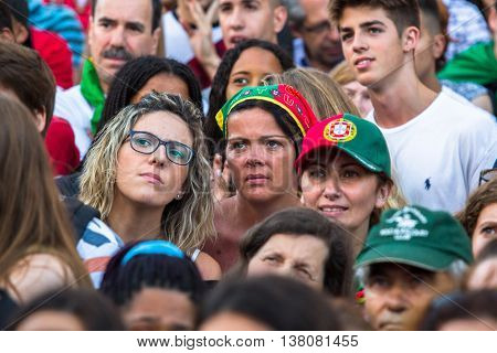 PORTO, PORTUGAL - JUL 10, 2016: Portuguese fans during translation of the football match Portugal - France final of the European championship 2016, in Liberdade Square at city center of Porto. 