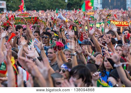 PORTO, PORTUGAL - JUL 10, 2016: Portuguese fans during translation of the football match Portugal - France final of the European championship 2016, in Liberdade Square at city center of Porto. 