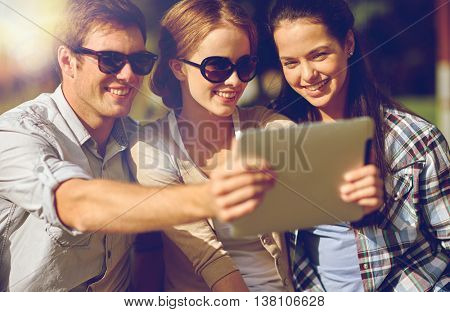 summer, technology, education and teenage concept - group of happy students or teenagers with tablet pc computer taking selfie