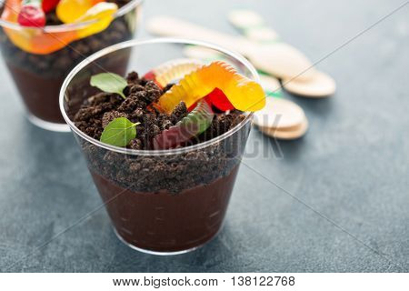 Children chocolate pudding dessert in a cup called dirt and worms