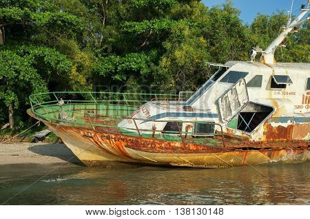 Labuan,Malaysia-July 12,2016: Abandoned broken ferry ship wreck known as Duta Muhibbah Dua beached on sea shore at Labuan island,Malaysia on 12th July 2016.
