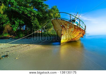 Labuan,Malaysia-July 12,2016: Abandoned broken ferry ship wreck known as Duta Muhibbah Dua beached on sea shore at Labuan island,Malaysia on 12th July 2016.