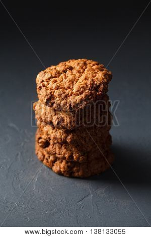 Close-up photo of oatmeal cokies stack on gray textural background