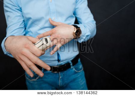 close up shop man holding dollars. suited. watch