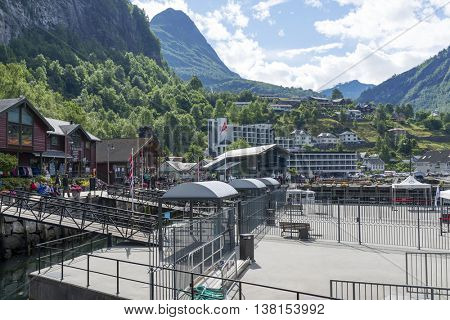 GEIRANGER, NORWAY - JUNE 29: Tourists walking through the seaport quay on June 29, 2016 in Geiranger, Norway. Geiranger is UNESCO heritage site.